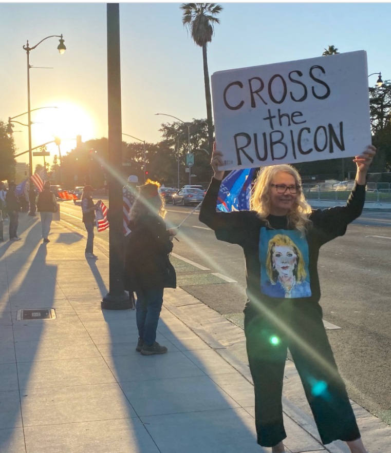 PHOTO Women Holding Cross The Rubicon Sign In Los Angeles