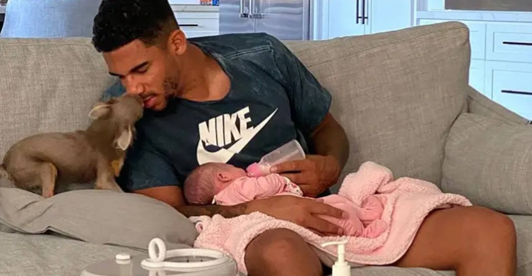 PHOTO Evander Kane Kissing His Dog While Feeding A Baby