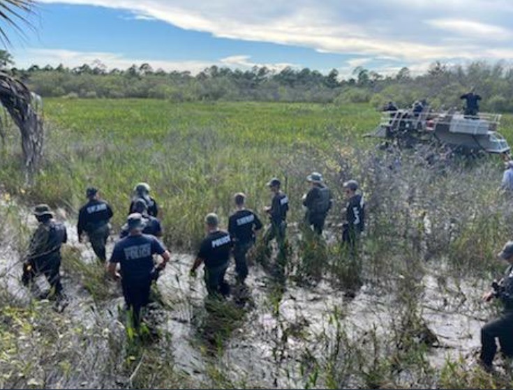 PHOTO 15 North Port Police Officers Searching Deep Terrain For Brian Laundrie On September 23rd