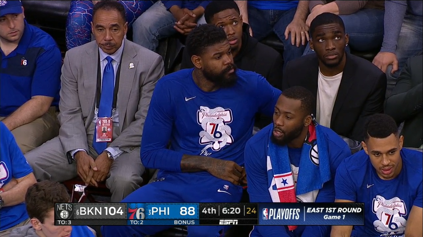 PHOTO Amir Johnson Looking At His Phone On Bench Next To Joel Embiid