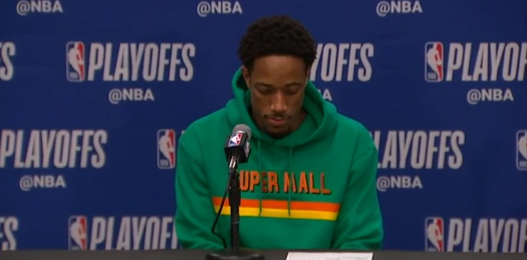 PHOTO Demar Derozan At The Podium In A Green Super Mall Hoodie