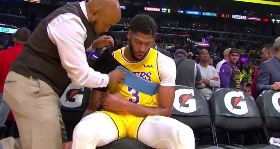 PHOTO Anthony Davis Being Held Against His Will On Bench As Some Guy Puts Wrap Around His Shoulder