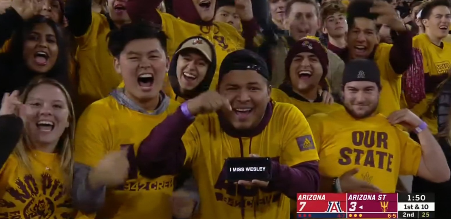 PHOTO Arizona State Fan With I Miss Wesley On His Phone While TV Camera Zooms In