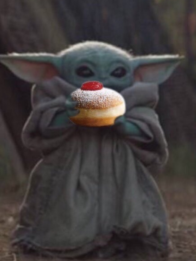 PHOTO Baby Yoda Celebrating The Holidays By Eating A Powedered Sugar Donut With A Cherry On Top