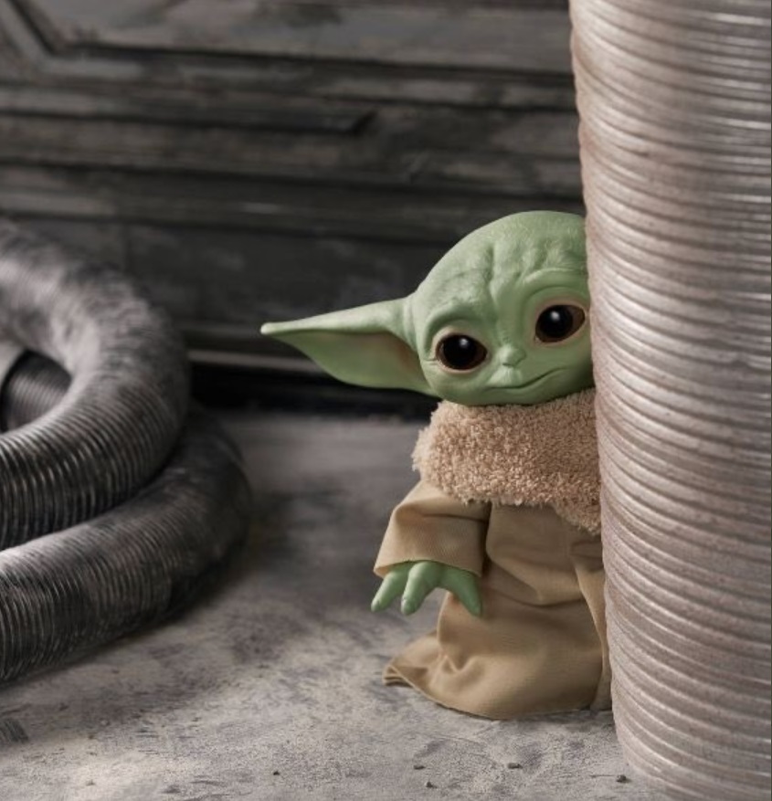 PHOTO Baby Yoda Hiding Behind A Stack Of Coins