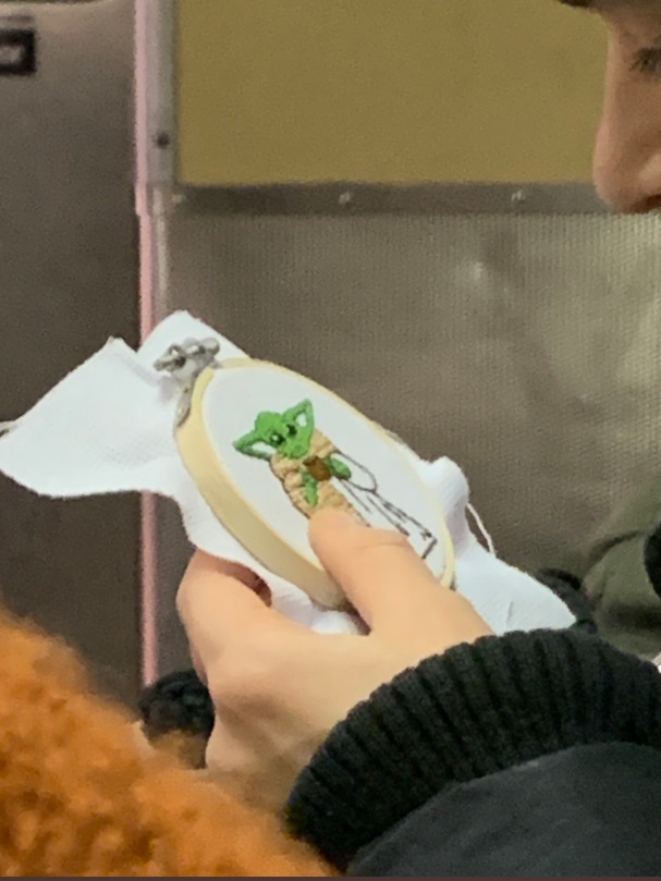 PHOTO Girl Needle Pointing Tiny Baby Yoda On New York Subway