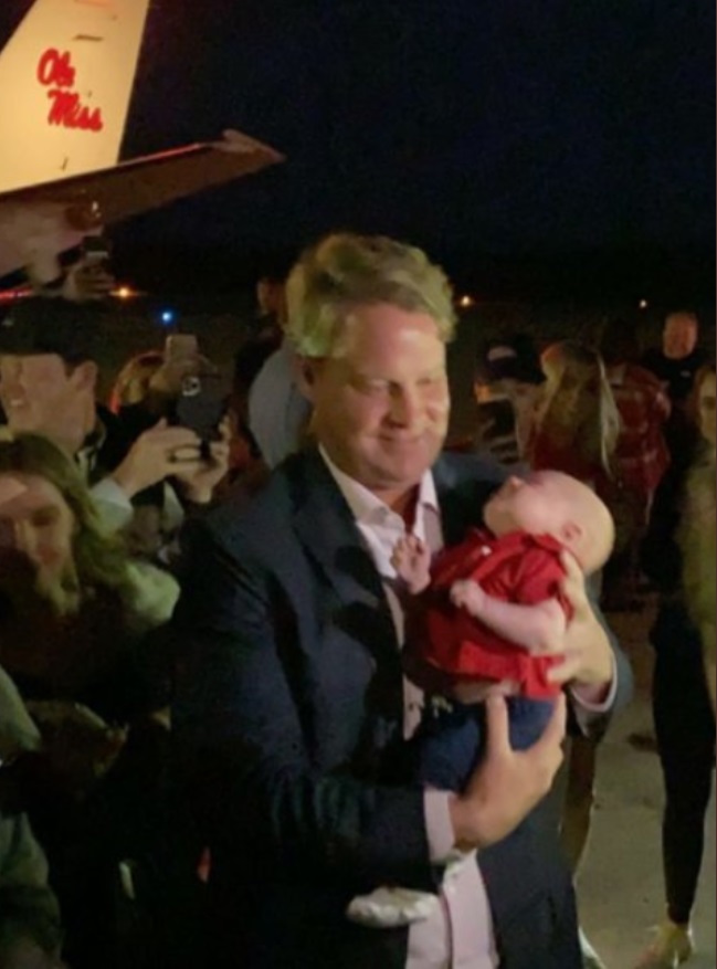 PHOTO Lane Kiffin Was Given Someones Baby To Hold As Soon As He Landed In Mississippi On Ole Miss Plane