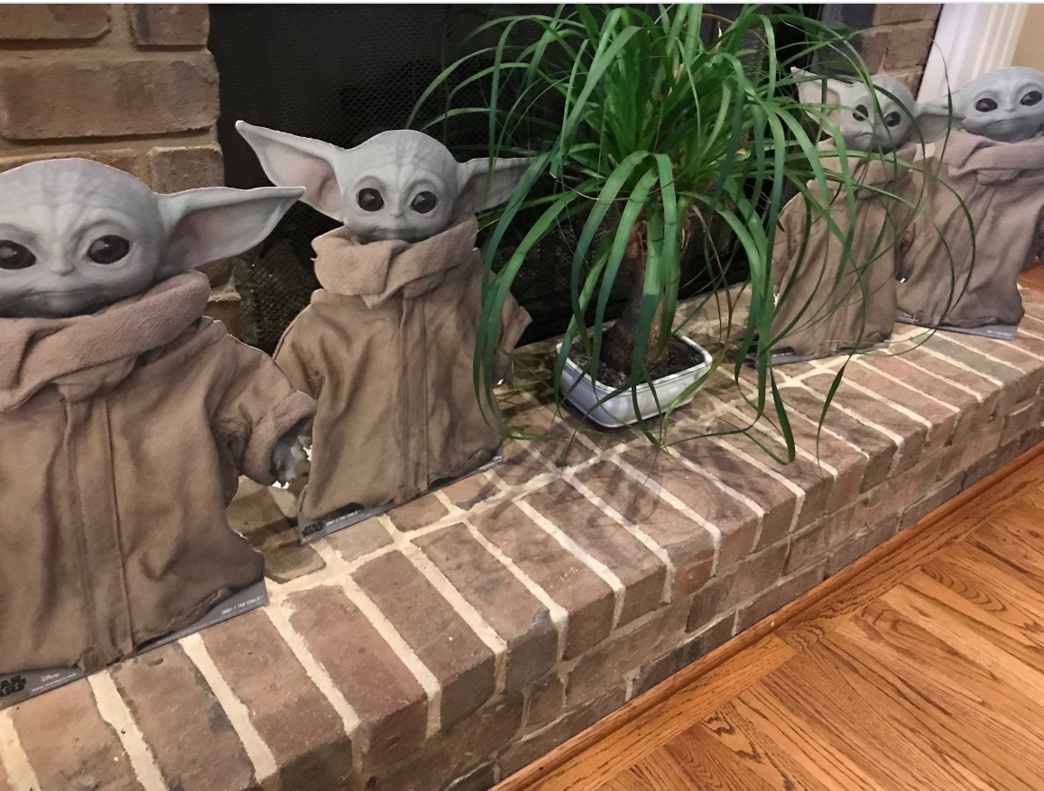 PHOTO Baby Yoda Cardboard Cutouts By The Fireplace