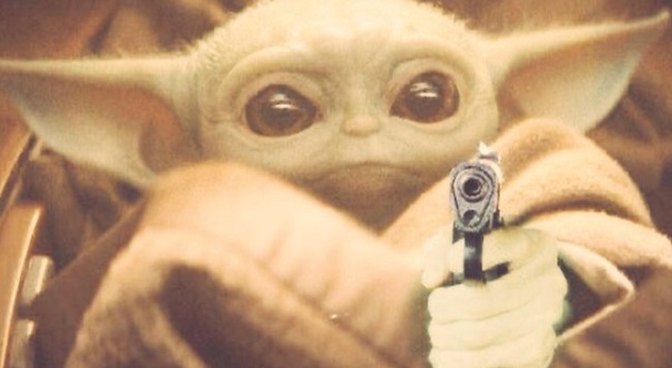 PHOTO Baby Yoda Holding A Pistol While Wrapped In A Robe