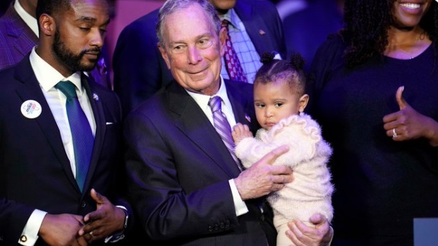 PHOTO Michael Bloomberg Trying To Look Innocent Holding A Baby