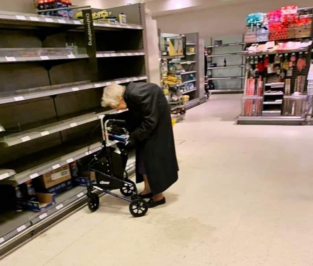 PHOTO Old Lady At Dollar Tree Looking For Items She Needs But The Shelves Are Empty During Corona Virus Outbreak