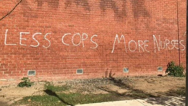 PHOTO Less Cops More Nurses On Wall In Melbourne