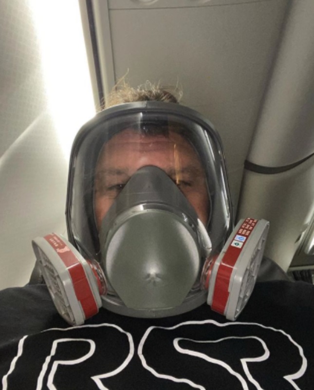 PHOTO NFL Agent Drew Rosenhaus Using Spaceship Type Breathing Face Mask To Travel On Airplane To Meet With NFL Draft Picks