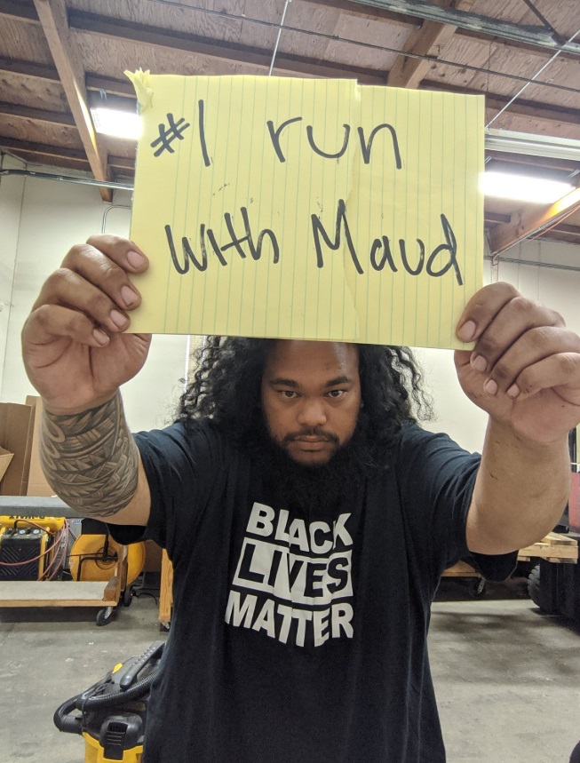 PHOTO Man In Black Lives Matter T-Shirt Supporting Ahmaud Aubrey With #1 Run With Maud Sign