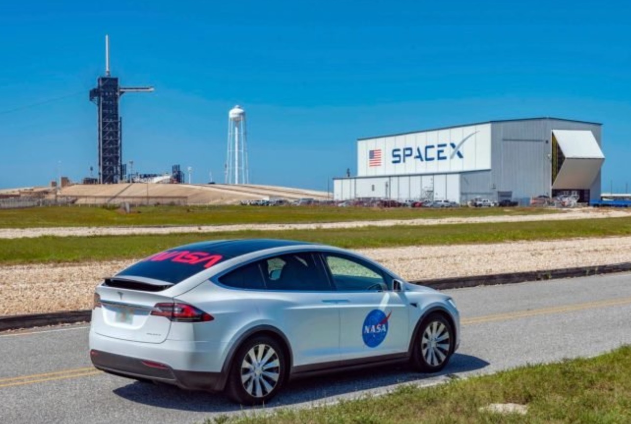 PHOTO NASA Tesla Driving Past SpaceX Building