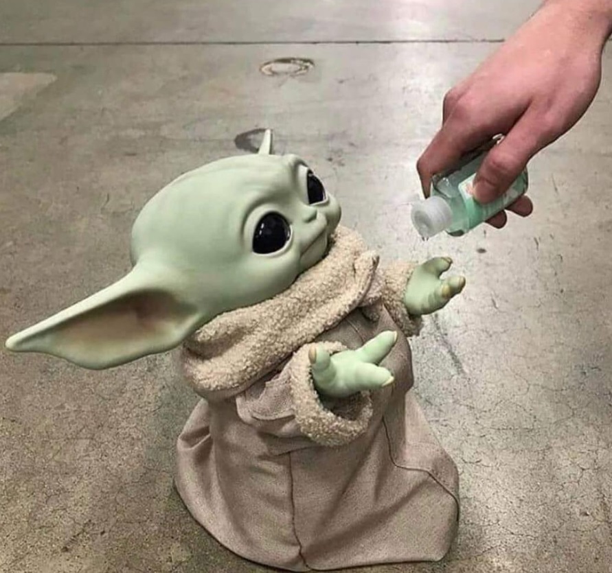 PHOTO A Human Giving Baby Yoda Hand Sanitizer