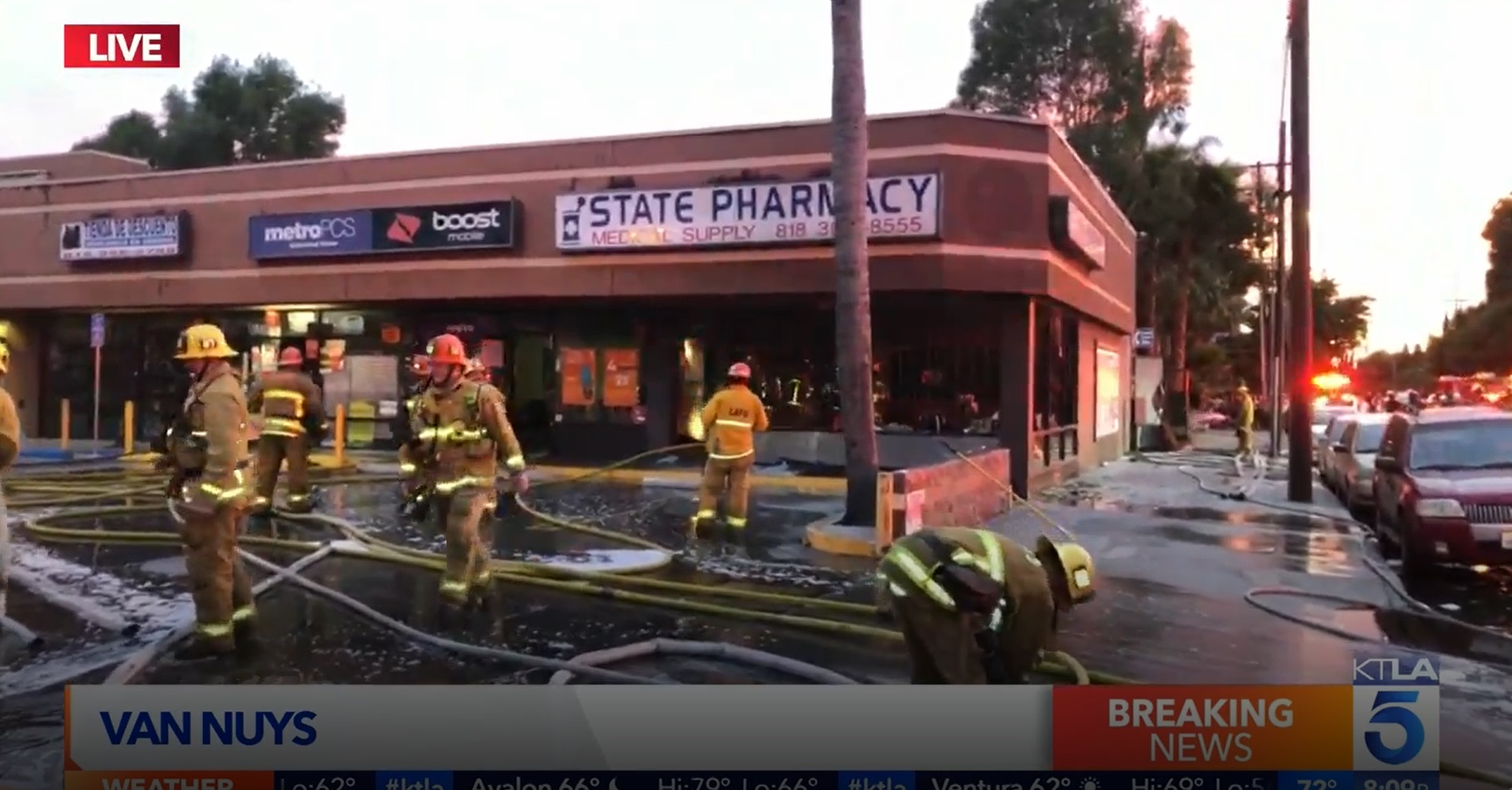 PHOTO Fire Fighters Trying To Put Out Fire In Van Nuys Near Shooting Center