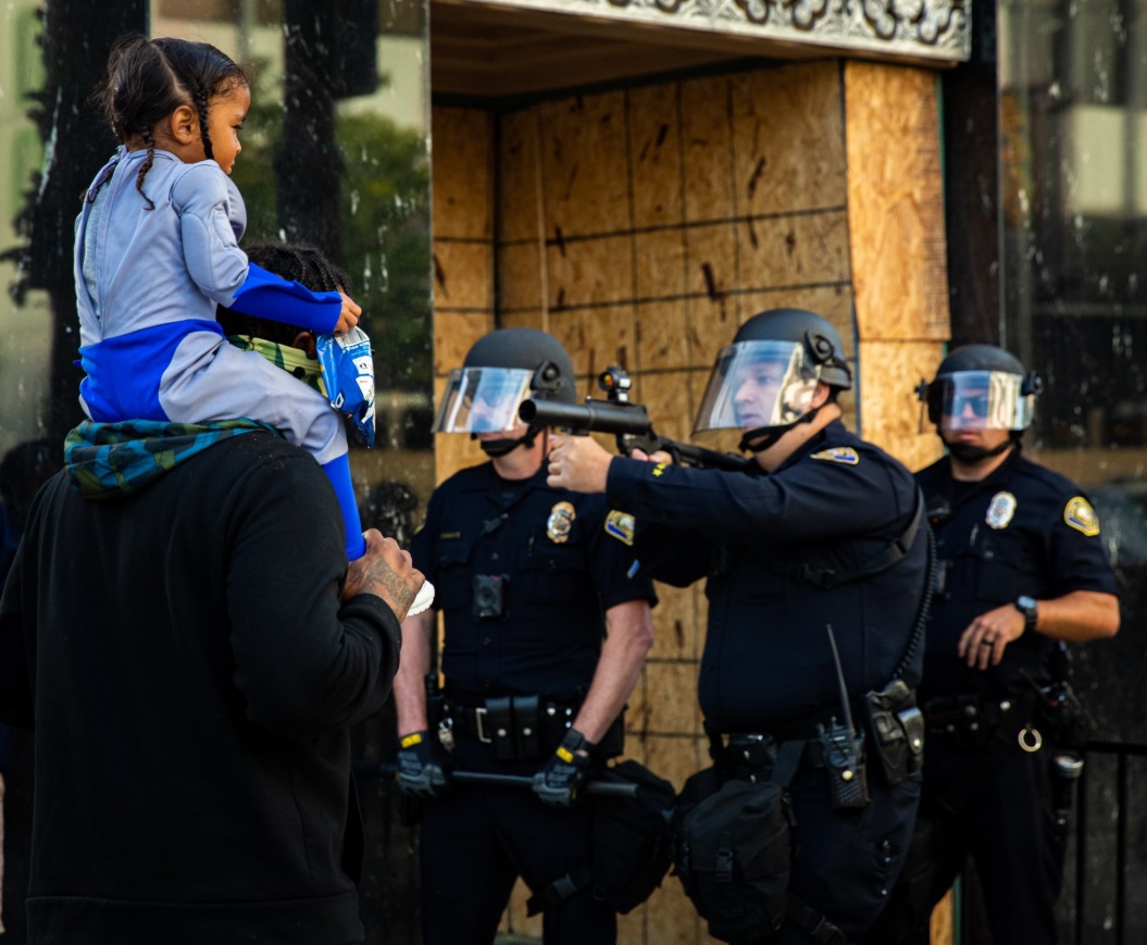 PHOTO White Police Officer In Long Beach Pointing Weapon At Black Man's Young Daughter