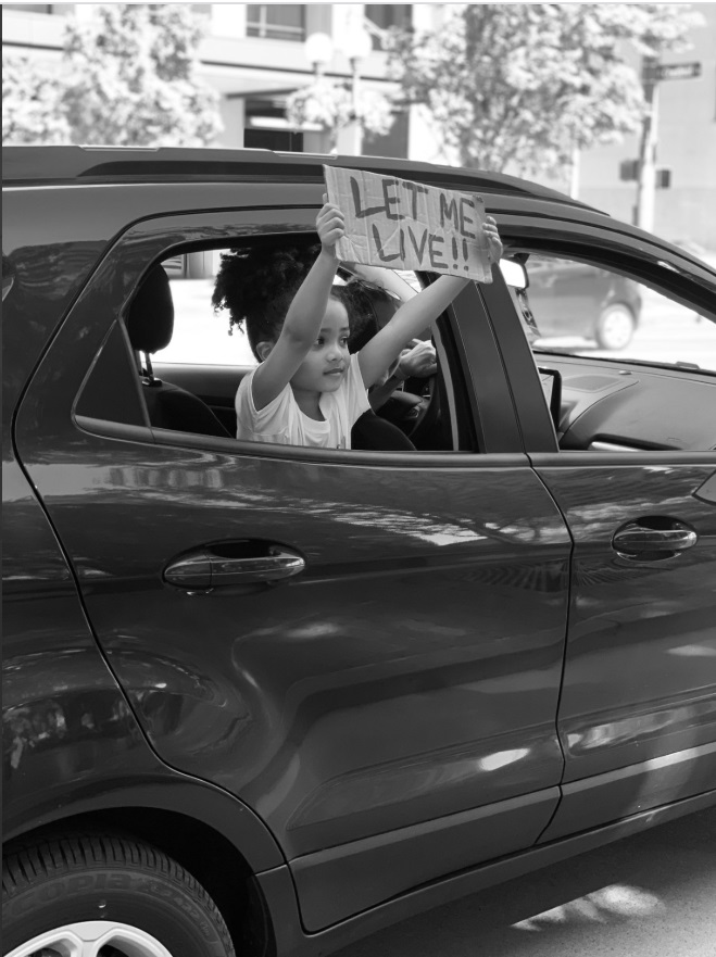 PHOTO Young Girl Holds Sign Out Window That Says Let Me Live