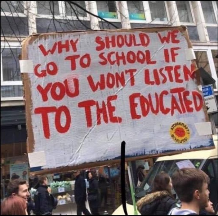 PHOTO Why Should We Go To School If You Won't Listen To The Educated Sign Directed At Kayleigh McEnany