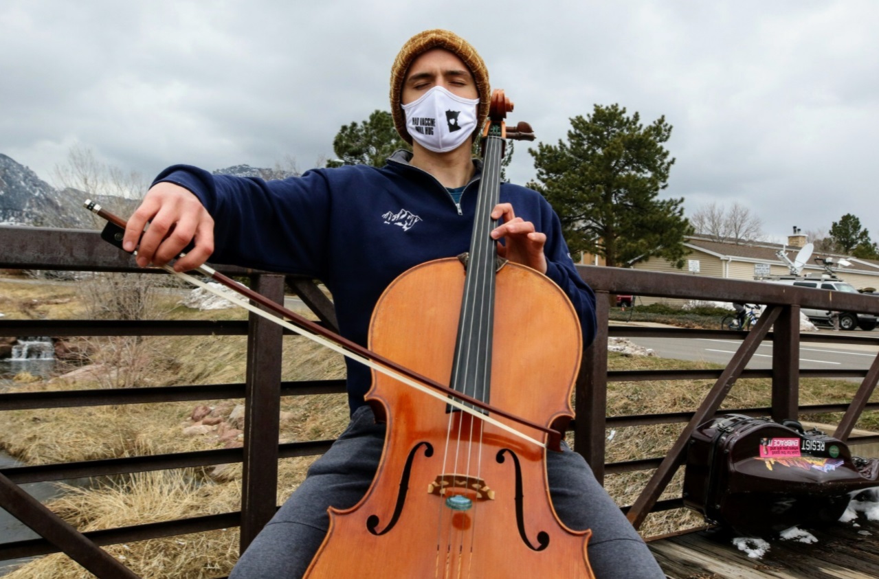 PHOTO Man Playing Musical Instrument Outside Of Boulder Colorado Memorial For Victims Of Shooting