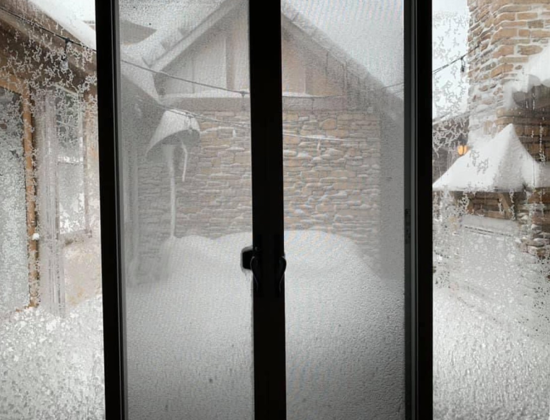 PHOTO South Denver Home Courtyard Covered Halfway Up The Wall In Snow