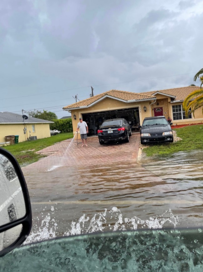 PHOTO Florida Man Watering The Hurricane From His Driveway