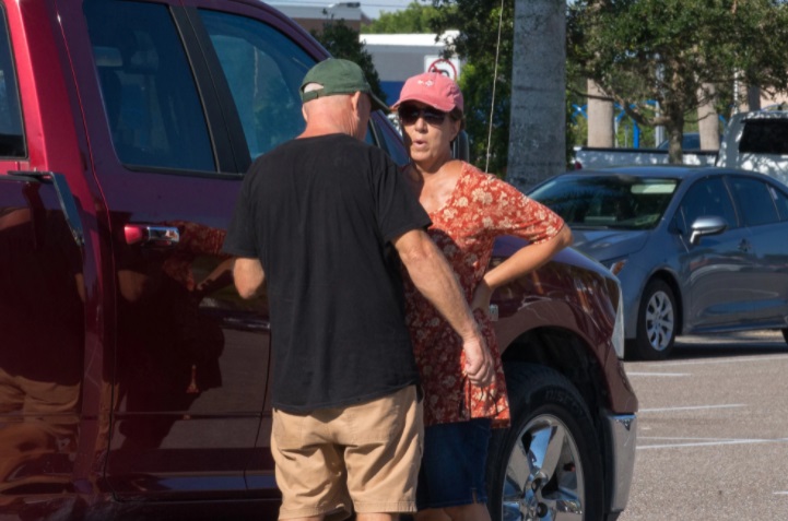 PHOTO Brian Laundrie's Parents Having A Private Chat In A Parking Lot While Camera Are Watching Them