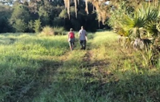 PHOTO Brian Laundrie's Parents Strolling Through Florida Reserve Looking For Their Son With No Cares In The World