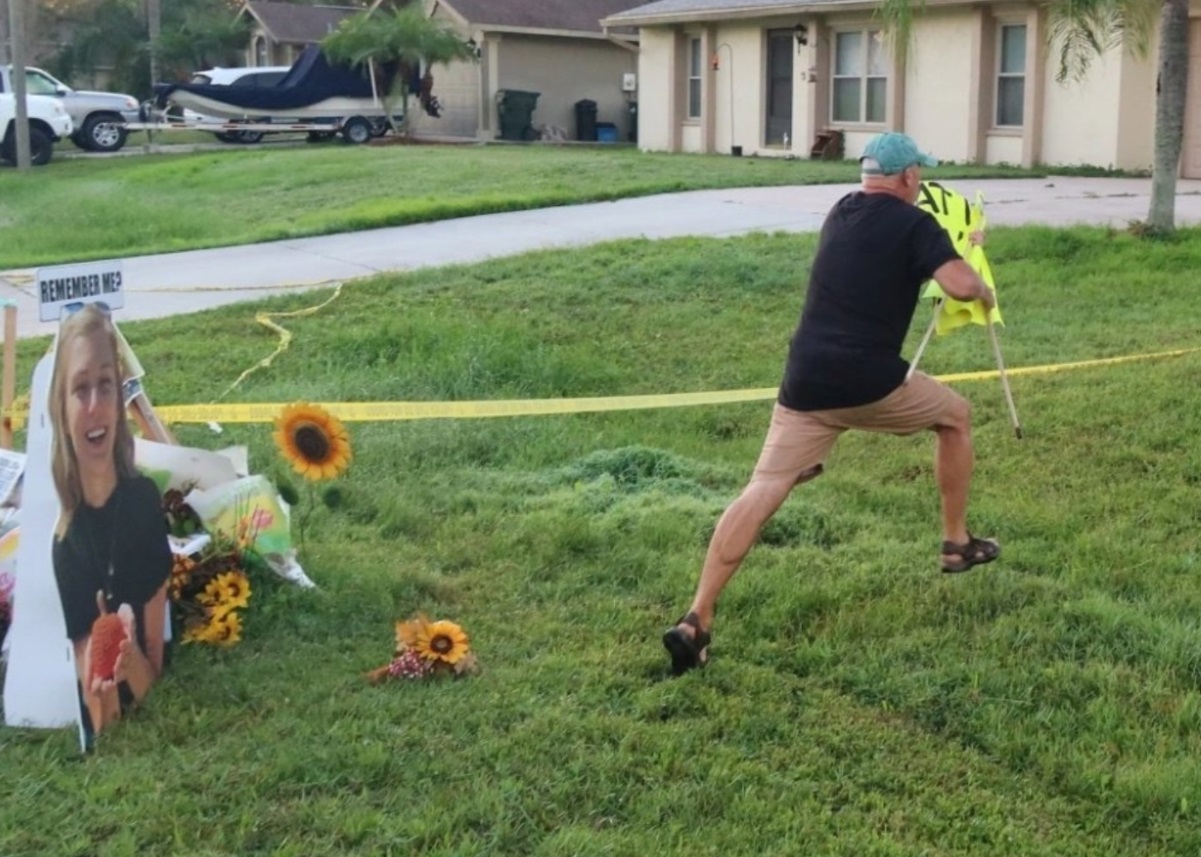 PHOTO Christopher Laundrie Using All Of His Leg Muscles To Remove Sign From His Lawn That Says What If It Was Cassie