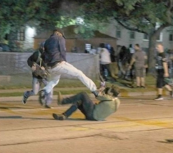 PHOTO Dude Stepping On Kyle Rittenhouse's Hand And Trying To Smash It While He Holds His Gun And Points It At The Man