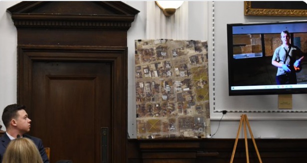 PHOTO Kyle Rittenhouse With A Smug Look On His Face As He Watches Video Of Himself Holding An AR-15 On Courtroom TV