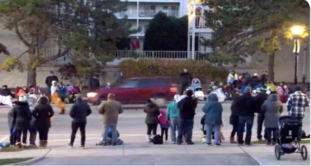 PHOTO Of Christmas Party Attendees Standing On Sidewalk Watching As Darrell Brooks Drives SUV Through Crowd