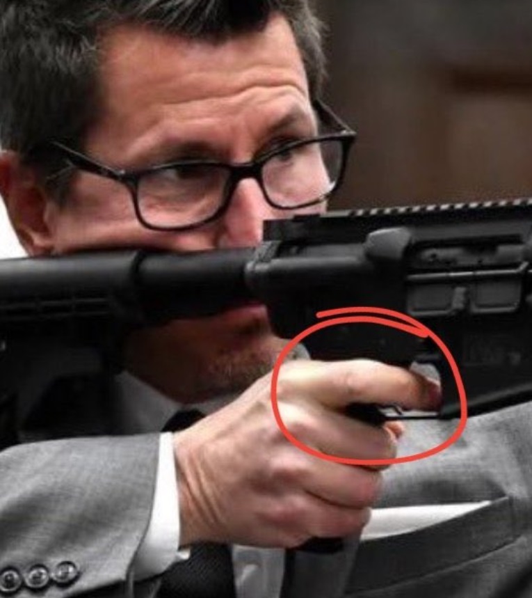 PHOTO Thomas Binger With His Hand On The Trigger While Point Gun At Jury