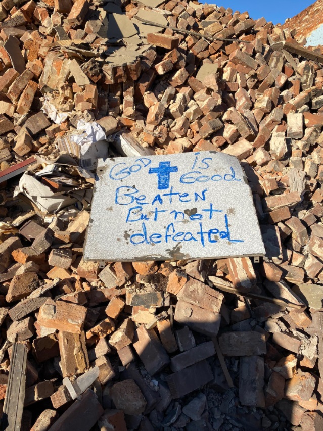 PHOTO God Is Good Beaten But Not Defeated Sign Amongst The Debris In Mayfield Kentucky