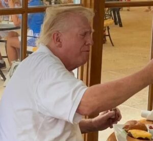 PHOTO Donald Trump Was Eating A Hamburger With Cheese And Had Messy Hair While Joe Biden Was Talking With The Leade Of Ukraine