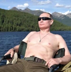 PHOTO Putin Sitting In The Russian Mountains Sunbathing Shirtless After Banning Joe Biden From Country