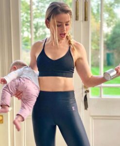 PHOTO Amber Heard Holding Her Baby While Lifting Weights With One Hand While Having No Regard For The Young Child's Life