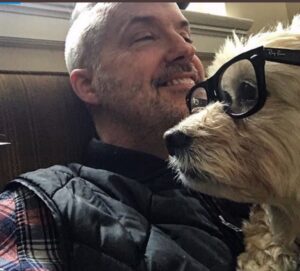 PHOTO Eric Boehlert Sitting On His Couch And Put His Glasses On His Dogs Face