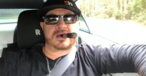 PHOTO Randy Tillim Smoking A Cigar While Driving His Car