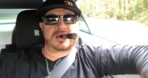 PHOTO Randy Tillim Wearing A Savage Garage Hat While Driving A Rolls Royce