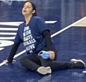 PHOTO Woman Who Glued Herself To The Floor In Minneapolis Was Wearing A Keep Animals Alive T-Shirt