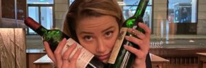 PHOTO Amber Heard Holding Two Bottles Of Wine Between Her Face