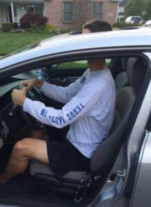 PHOTO Casey White Driving A Ford Edge With His Head Above The Sun Roof Because He's Too Talk To Fit In The Seat Like Normal Meme