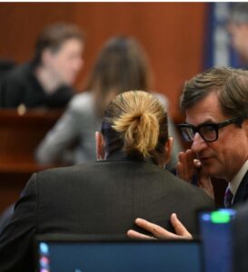 PHOTO Johnny Depp's Lawyer Whispering Secrets Into His Ear