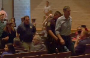 PHOTO Of Beto Being Escorted Out Of Briefing Room For Clowning Greg Abbott