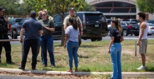 PHOTO Scared Parents Talking To Each Other Outside Robb Elementary School This Afternoon