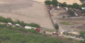 PHOTO 18-Wheeler In San Antonio With Migrants In It Was Right Next To Train Tracks