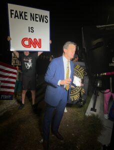 PHOTO CNN Did Live Shot Outside Mar-A-Lago After Trump's House Was Raided And Dude Was Right Behind Camera With Fake News Is CNN Sign