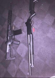 PHOTO Close Up Of Ethan Miller's AR-15 Rifle And 12 Gauge Pump Action Shotgun